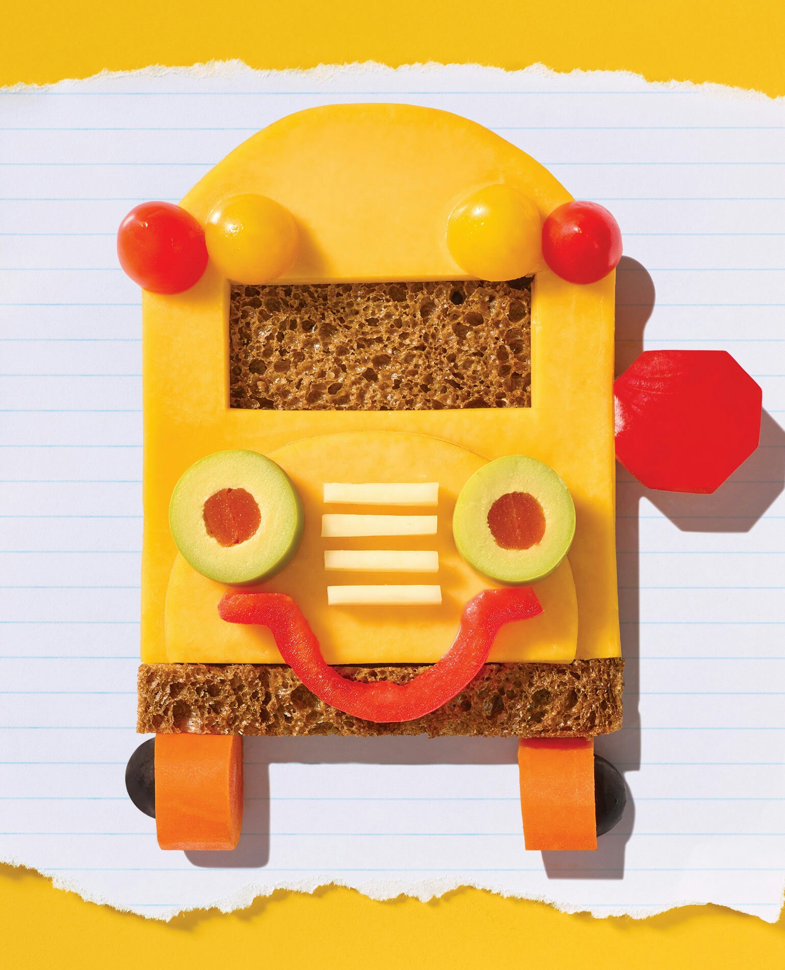 Smiling school bus made out of kids school lunch items